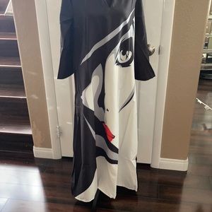 A woman’s dress size large very unique with a woman’s face on the front new